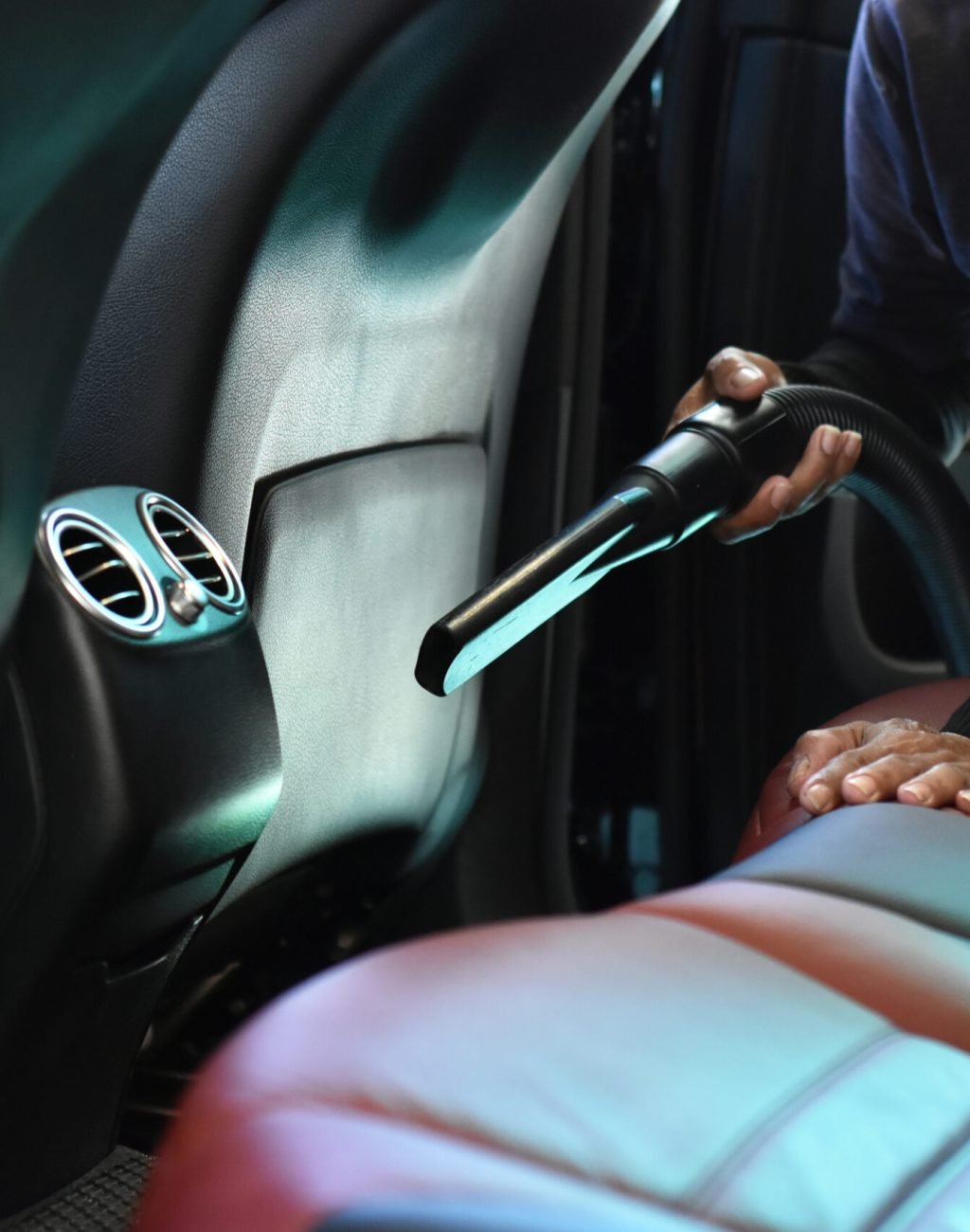worker-cleaning-interior-back-seat-carpet-luxury-cars-by-wet-vacuum-machine Car wash concept, Worker cleaning of interior back seat and carpet luxury cars by wet vacuum machine.